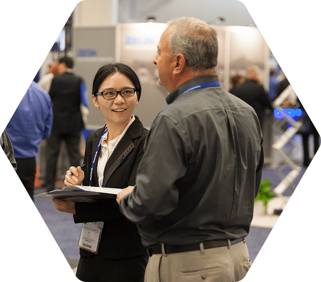 Man and woman having a conversation at an indoor conference